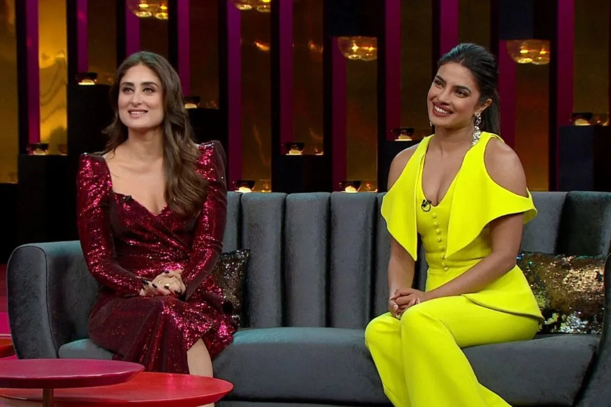 Kareena Kapoor and Priyanka Chopra smiling on the Koffee With Karan set.