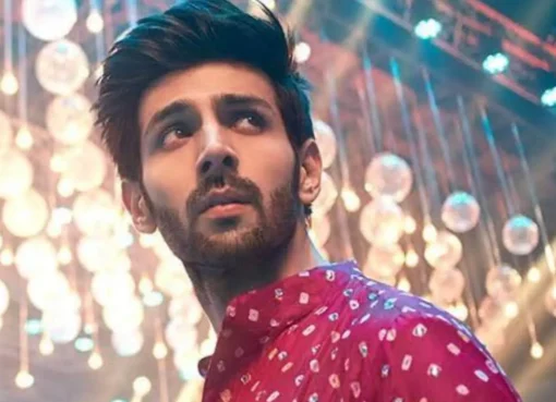 Kartik Aaryan smiling, holding a National Film Award.