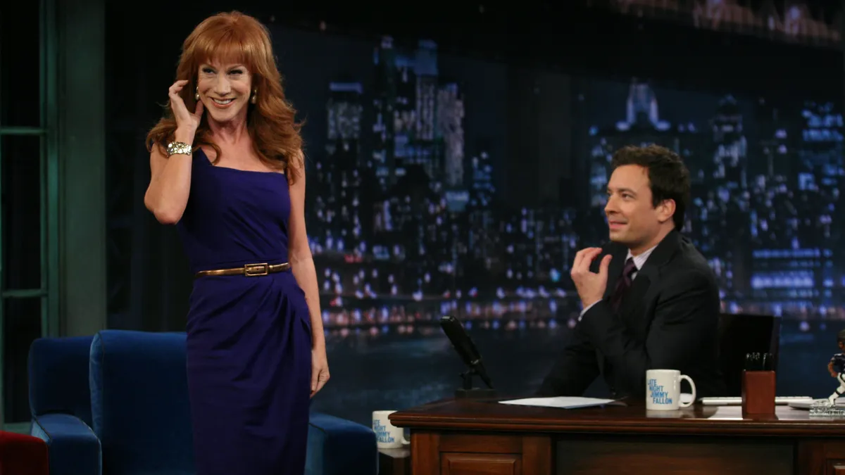 Comedian Kathy Griffin on stage with a microphone.