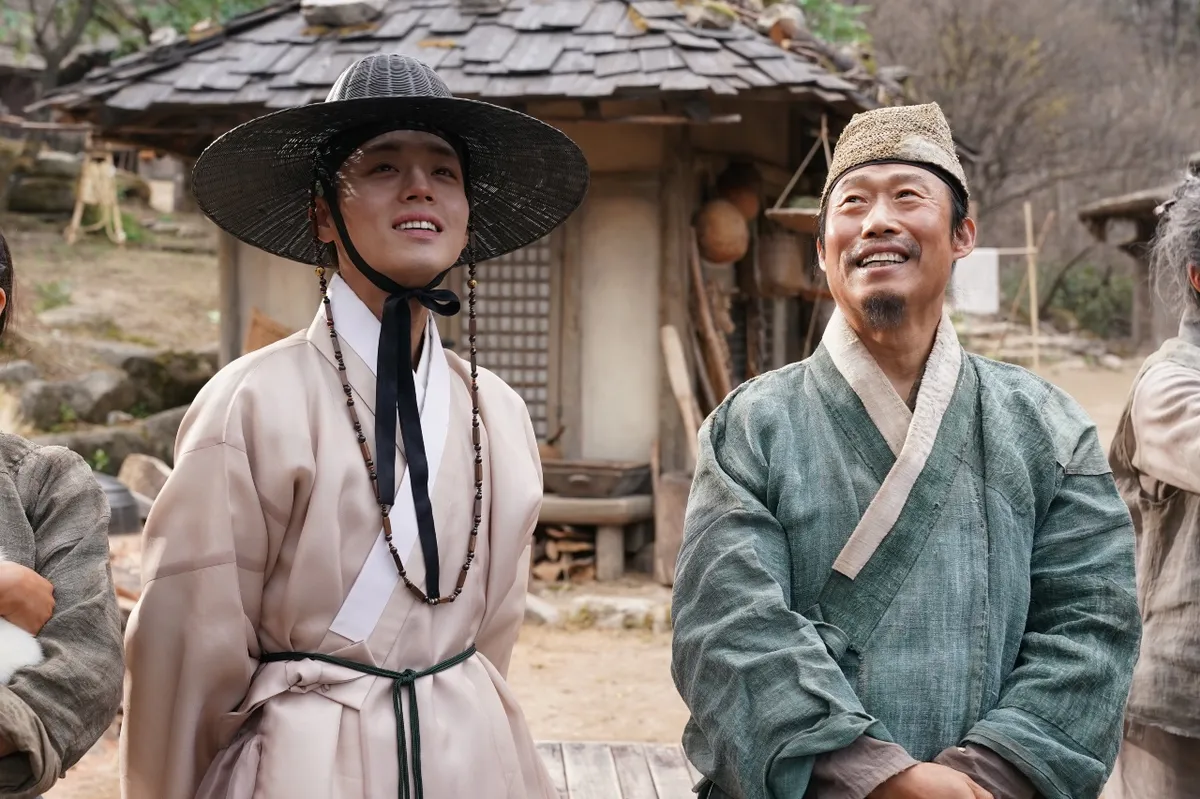 A vibrant movie screen showing a bustling Korean film scene with an excited audience.