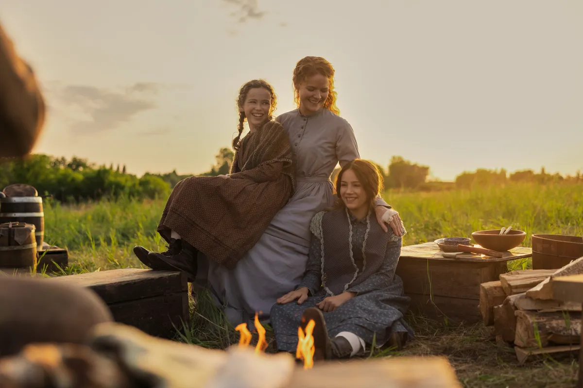 A screenshot from 'Little House on the Prairie' showing a family outdoors.