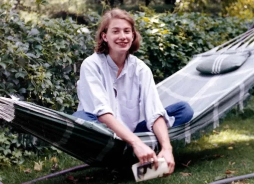A serene photo of Mary Oliver, perhaps in a natural setting like a garden or forest.