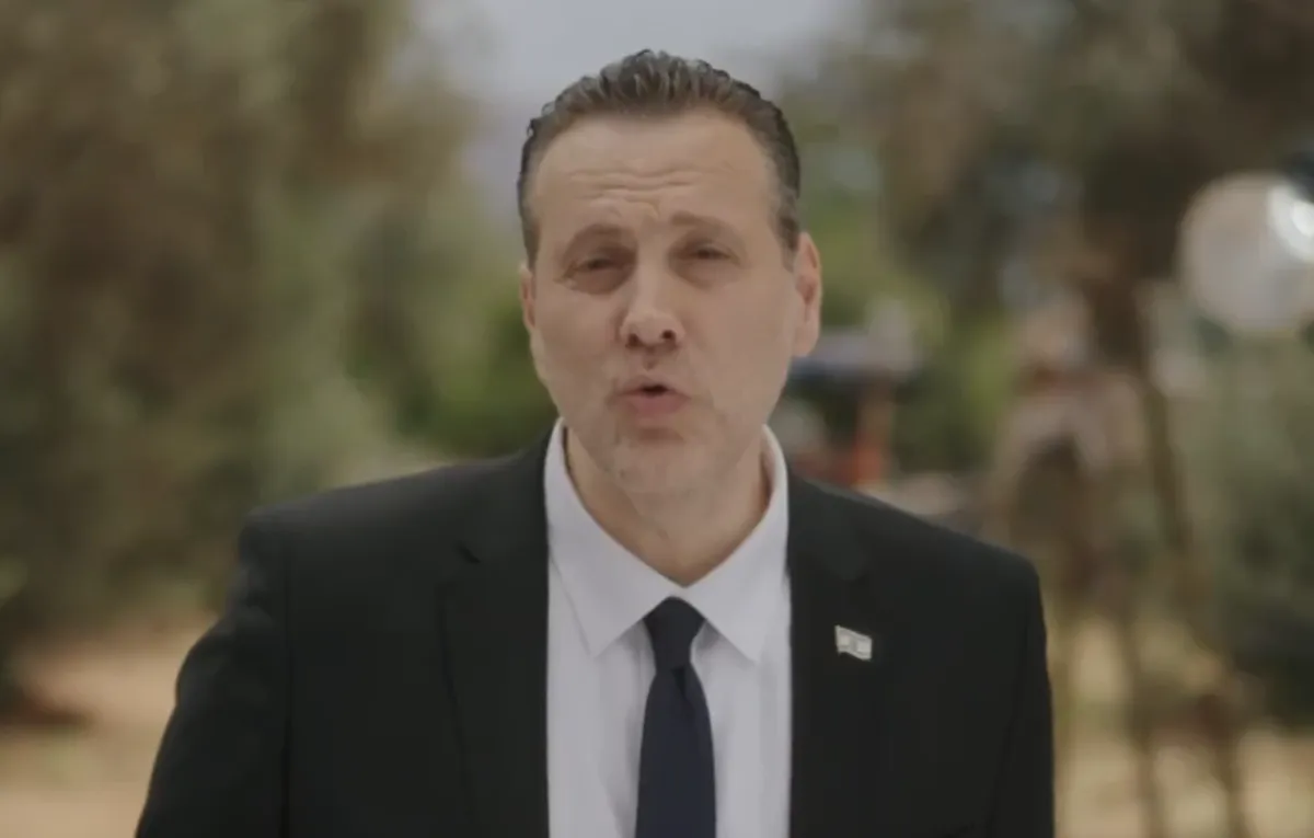 A serious-looking man, Miki Zohar, speaking in a campaign video.