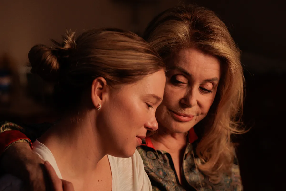 Léa Seydoux in a dramatic, dimly lit scene, possibly at a piano or on a stage.