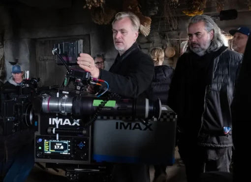 Christopher Nolan looking serious while discussing his film projects.