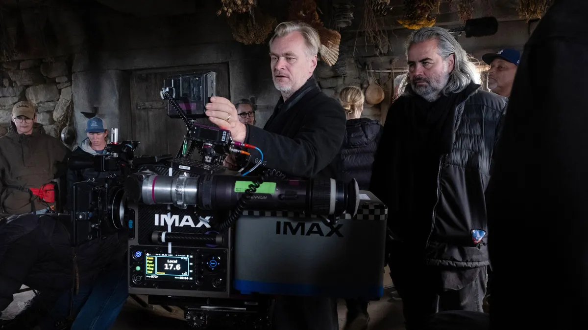Christopher Nolan looking serious while discussing his film projects.