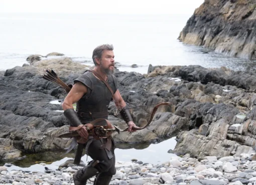 A dramatic shot from Christopher Nolan's 'The Odyssey' showing Matt Damon as Odysseus on a stormy sea.