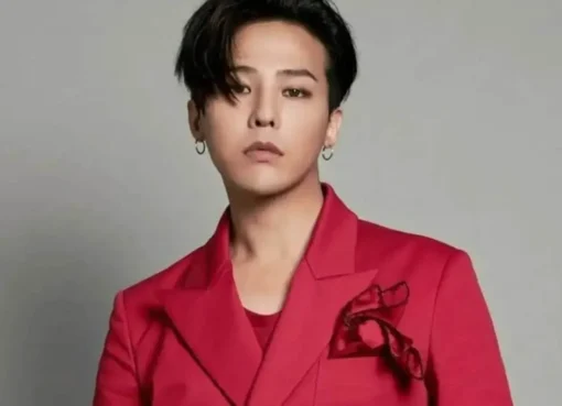 G-Dragon looking stylish and serious at a UNESCO event, possibly in a suit.