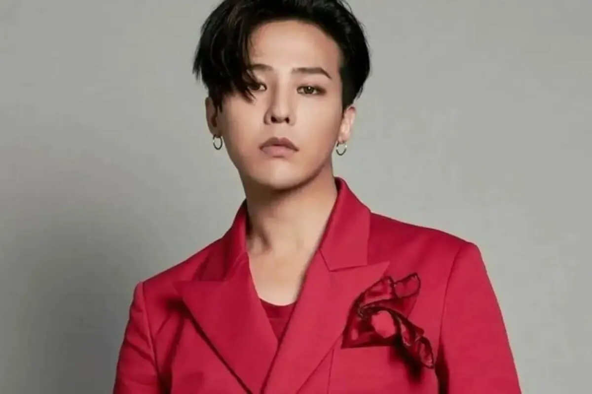 G-Dragon looking stylish and serious at a UNESCO event, possibly in a suit.
