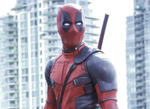 Close-up of Ryan Reynolds as Deadpool, wearing his iconic red and black suit, looking mischievous.