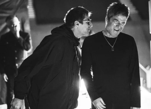 Liam and Noel Gallagher of Oasis performing together on stage
