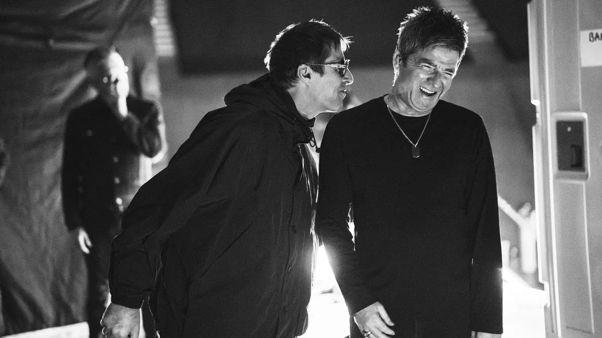 Liam and Noel Gallagher of Oasis performing together on stage