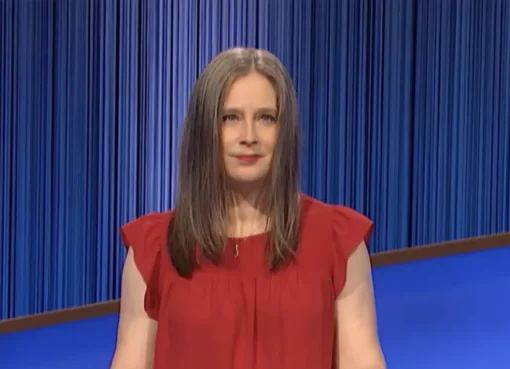 Courtney Shah smiling on the Jeopardy! stage during a game.