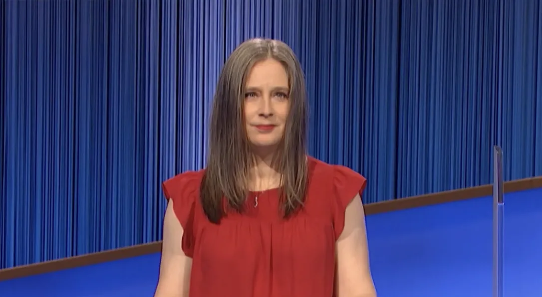 Courtney Shah smiling on the Jeopardy! stage during a game.