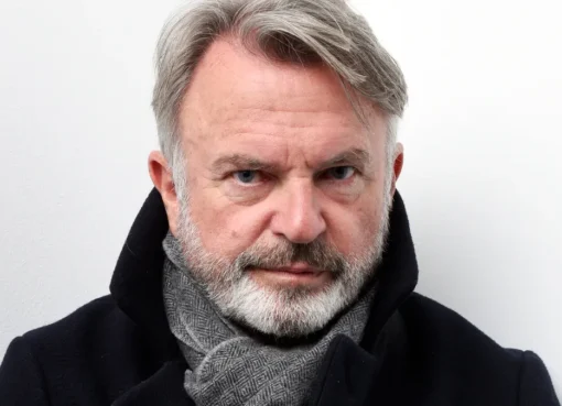 Photo of Sam Neill smiling.