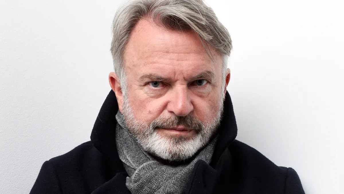 Photo of Sam Neill smiling.