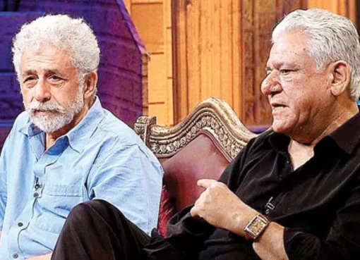 A candid, black and white photo of Om Puri with a subtle smile, reflecting thoughtfulness.