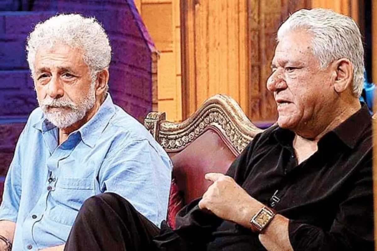 A candid, black and white photo of Om Puri with a subtle smile, reflecting thoughtfulness.