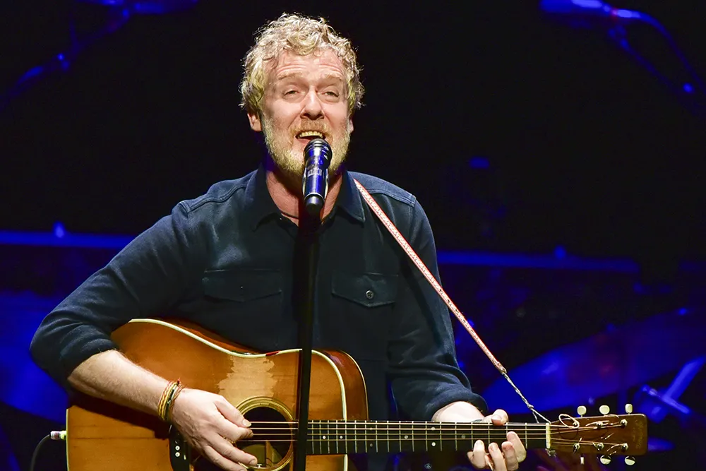 Glen Hansard, the musician and actor, performing with his acoustic guitar.