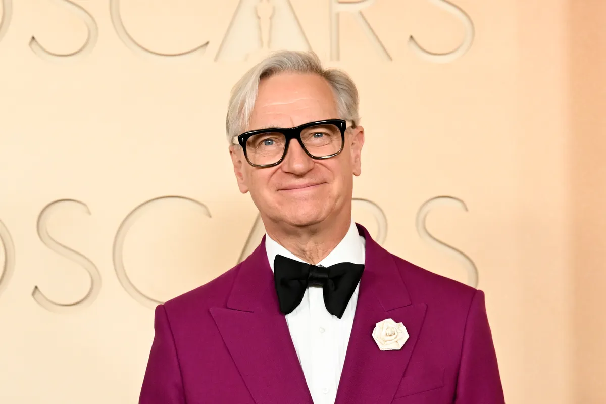 Paul Feig looking thoughtful, with a shadowy, suspenseful background suggesting a high school hallway.