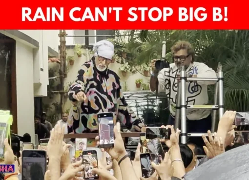 Amitabh Bachchan waves to fans outside his Jalsa residence during heavy Mumbai rains.