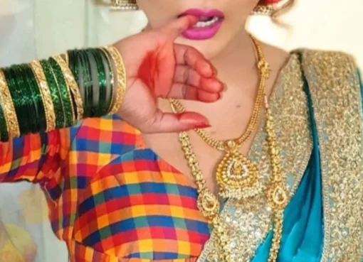 A dramatic photo of Rakhi Sawant with bold lighting.