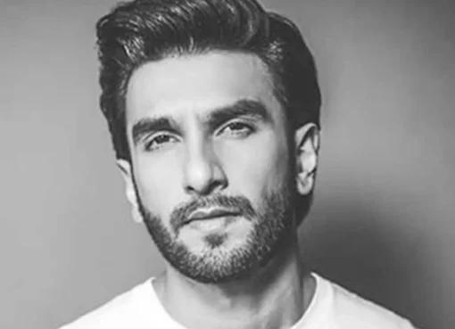 Ranveer Singh smiling with an intense backdrop