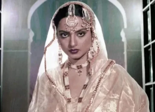 Rekha looking elegant in a traditional gold and cream saree
