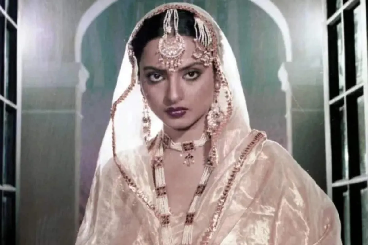Rekha looking elegant in a traditional gold and cream saree