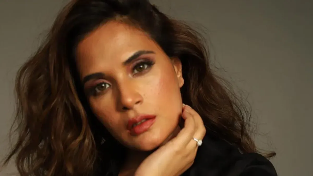 Richa Chadha smiling thoughtfully, possibly for a promotional photo.
