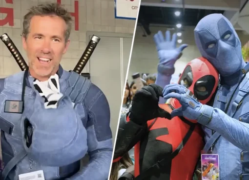 Ryan Reynolds in his red Deadpool costume walking through a crowd of fans