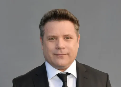 Sean Astin looking serious in a suit for his new movie A Social Contract