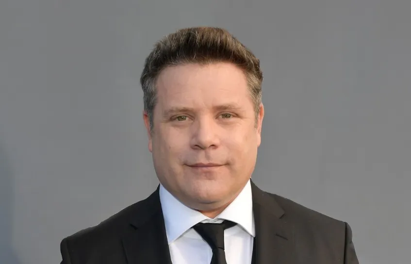 Sean Astin looking serious in a suit for his new movie A Social Contract