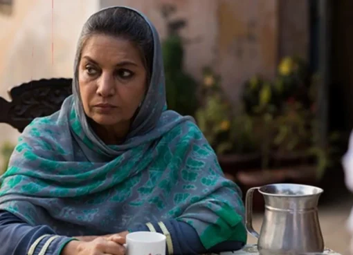 Shabana Azmi speaking at a public event with a serious expression