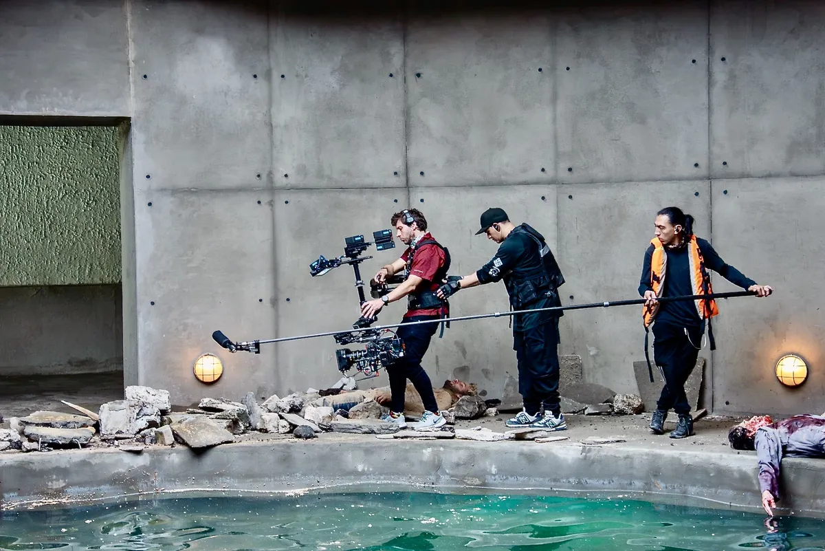Film crew setting up a movie shot in lush Colombian mountains with mist.