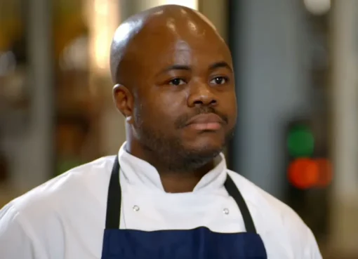 Chef Dom Taylor smiling in a kitchen.
