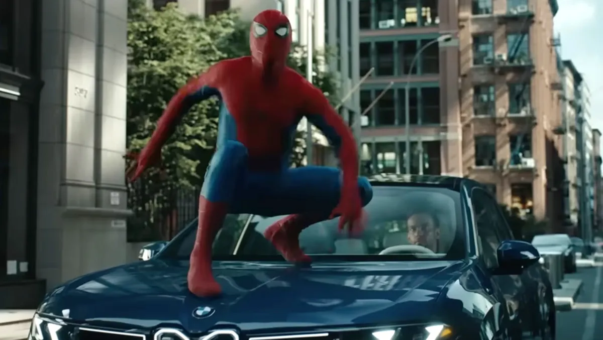 Spider-Man swinging through a city.