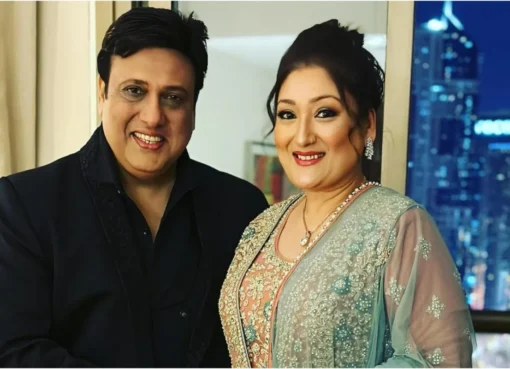 Sunita Ahuja and Govinda smiling and posing together at an event.
