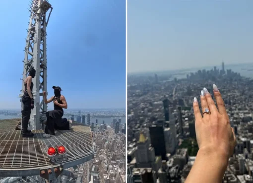 Two people standing on top of a very tall building with the city below