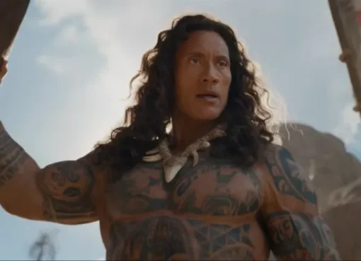 Dwayne Johnson as Maui with a flowing wig, laughing.