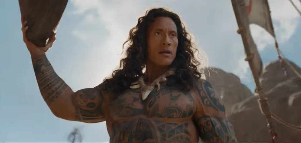 Dwayne Johnson as Maui with a flowing wig, laughing.