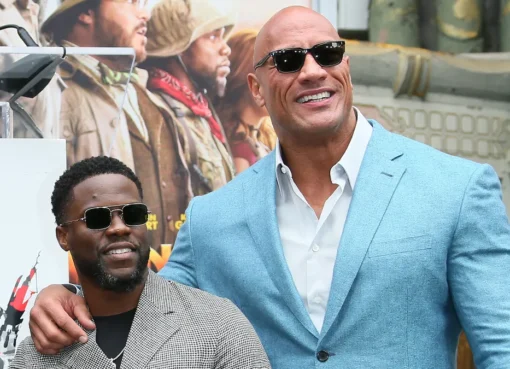 Dwayne Johnson and Kevin Hart smiling together, looking like they're about to tell a joke.