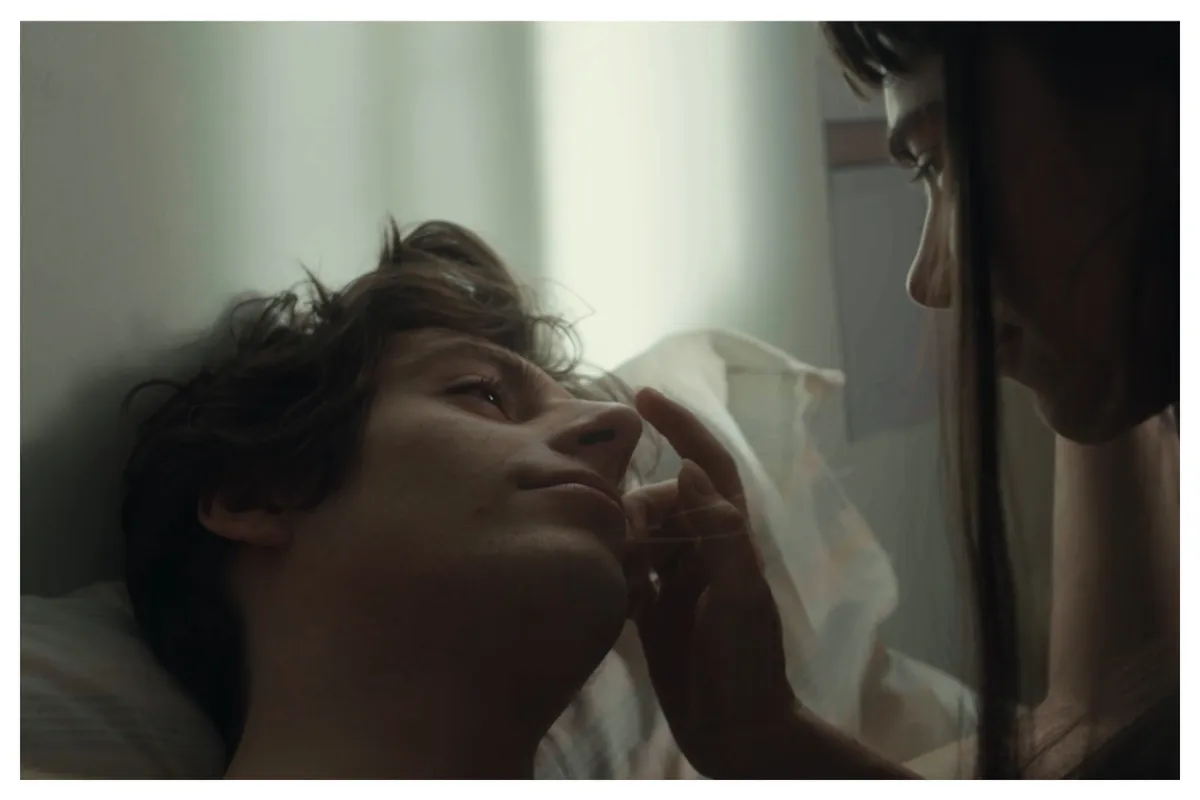 A still from the movie 'Lover, Not a Fighter' showing a young man looking relaxed.