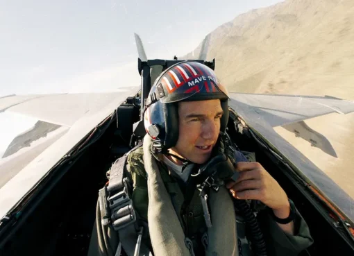 An artistic rendering of a Top Gun-themed attraction or building in Las Vegas, possibly with fighter jets or iconic imagery, near the famous "Welcome to Fabulous Las Vegas" sign.