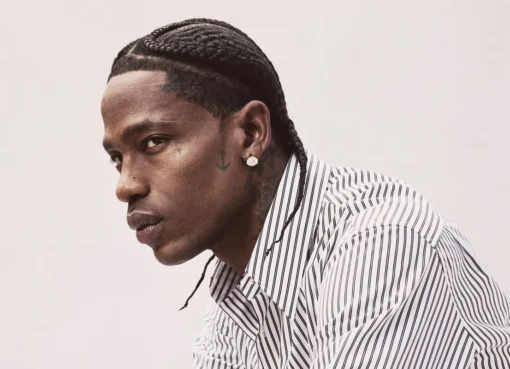 Travis Scott looking focused and stylish, possibly on a movie set or magazine cover.