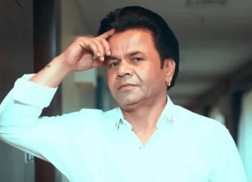 Rajpal Yadav looking thoughtful or serious, possibly outside a courtroom or in a formal setting.