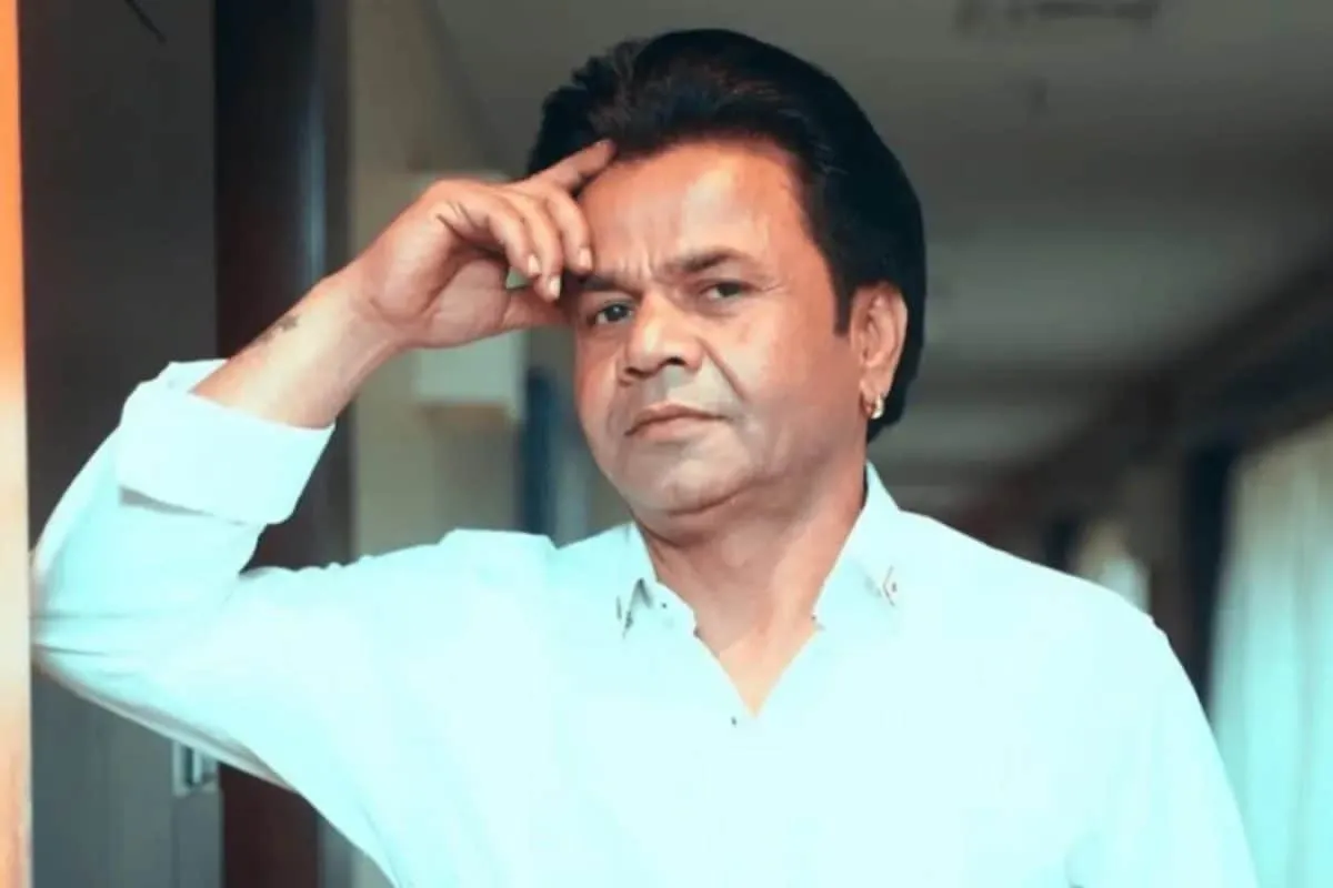 Rajpal Yadav looking thoughtful or serious, possibly outside a courtroom or in a formal setting.