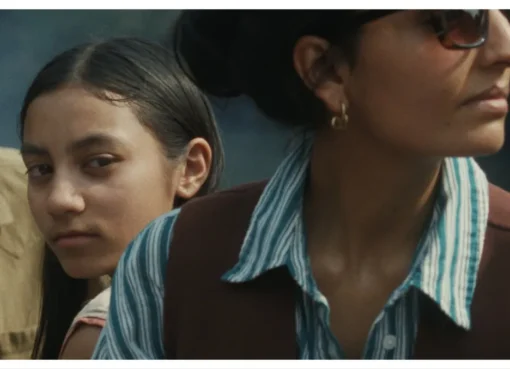 A film poster for 'Our Share of Sand' showing a young girl in a rural Indian setting looking thoughtful.