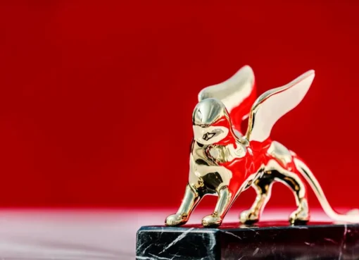 A photo of the Venice Film Festival logo with a red cross over it.