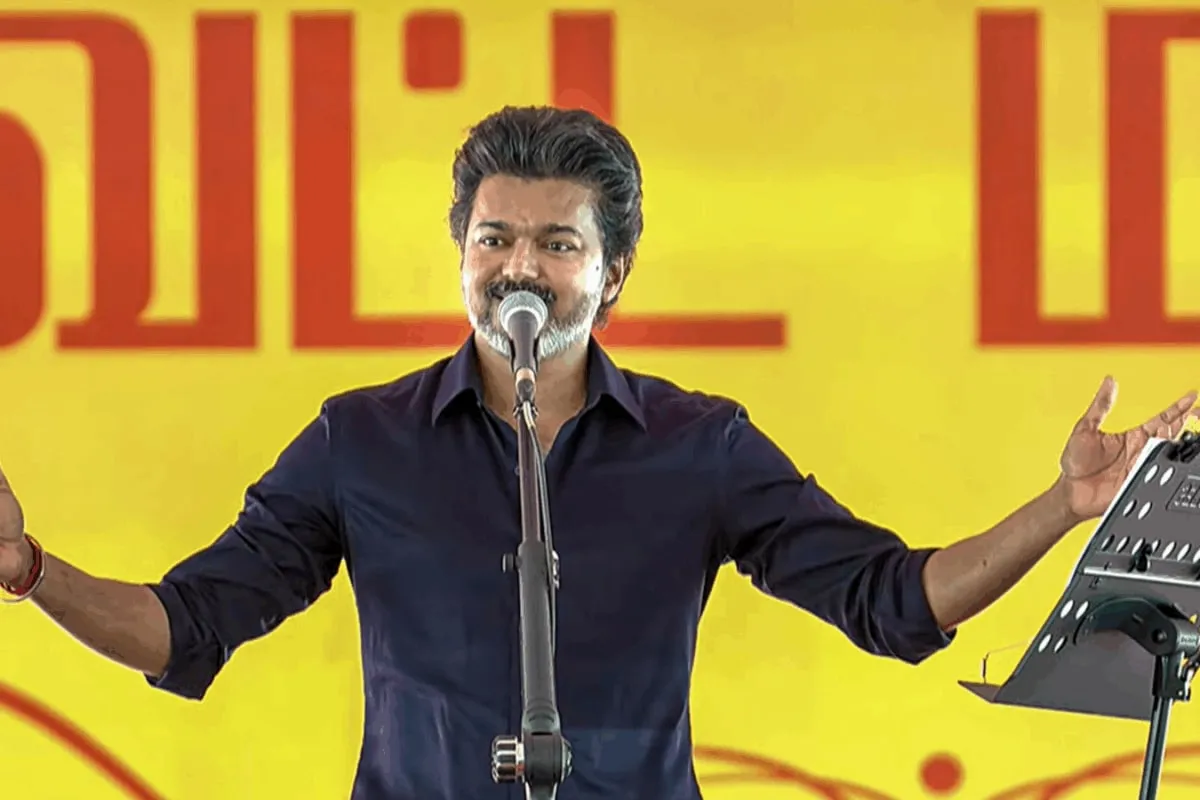 Actor Vijay speaking at a press event.